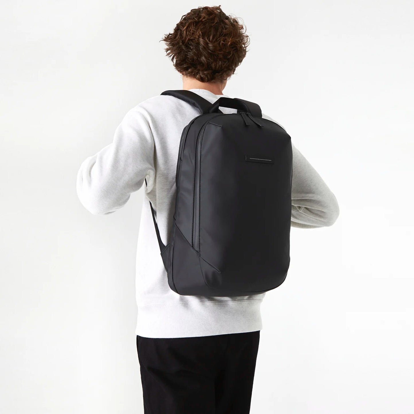 Best minimalist waterproof backpack with luggage sleeve for work and travel 